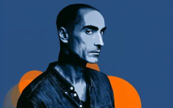 A stylized digital portrait of a man with a serious expression, wearing a denim jacket against a blue background with orange circular shapes.