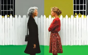 Two women stand facing each other in front of a white picket fence; the left side is gray with an older woman wearing black, while the right side is colorful with a younger woman in a red dress, arms crossed, both appearing serious.