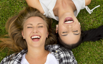 happy women lying on grass