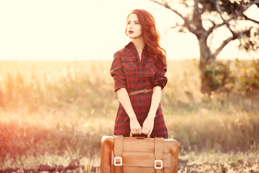 woman with suitcase in hand