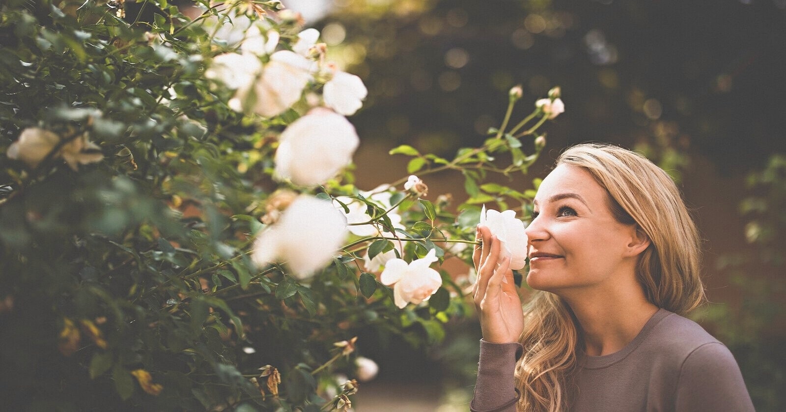 woman smelling the roses