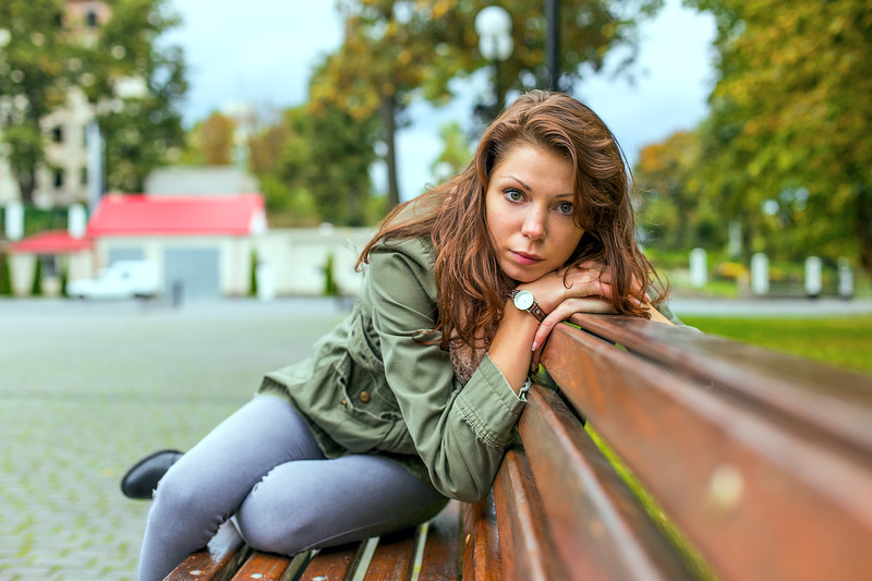 introverted woman sitting on bench