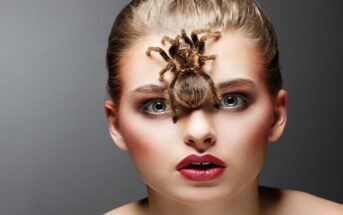 woman with tarantula on her face