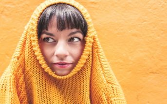 woman with jumper around head - concept of uncomfortable feelings