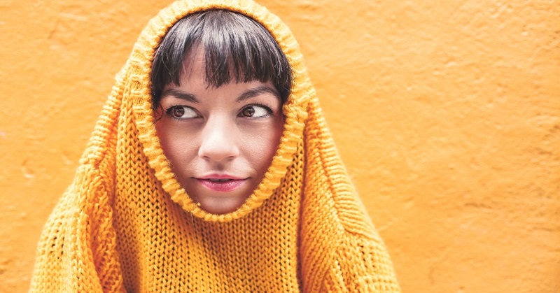 woman with jumper around head - concept of uncomfortable feelings