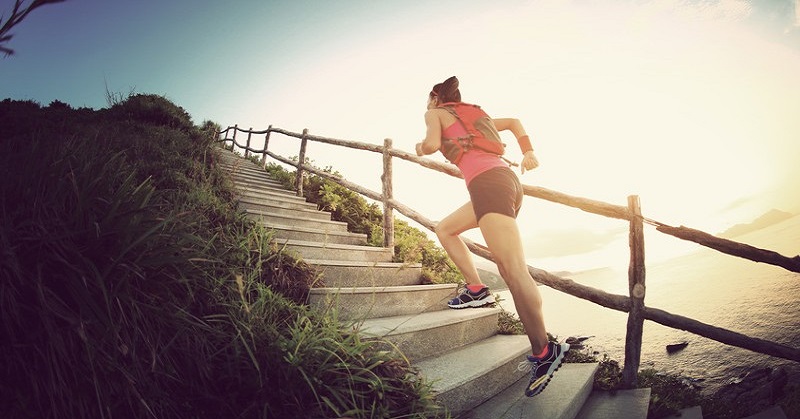 woman running up steps - illustrating not giving up