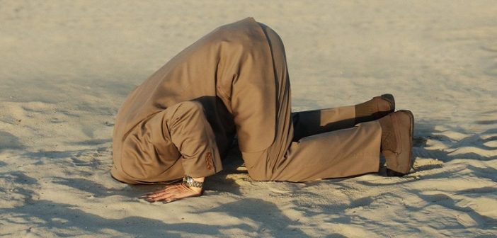 man with head in the sand