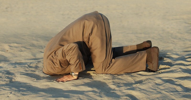 man with head in the sand