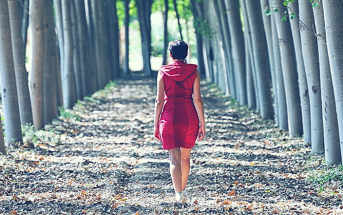 woman walking wooded path