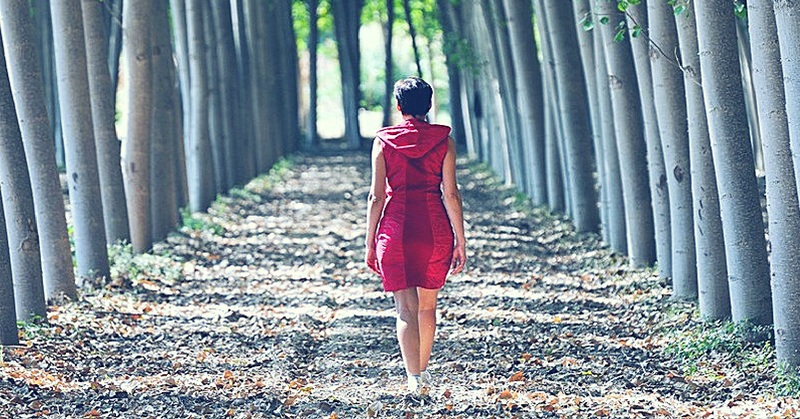 woman walking wooded path