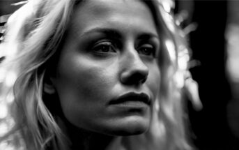 black and white photo of a pensive blonde woman, head and face only