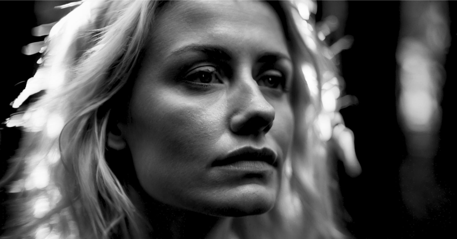 black and white photo of a pensive blonde woman, head and face only