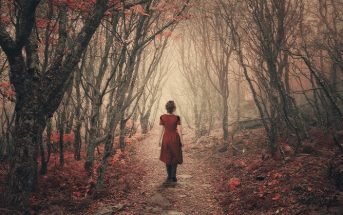woman walking in misty woods