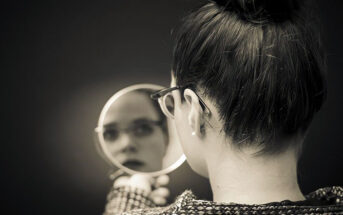 woman looking in the mirror