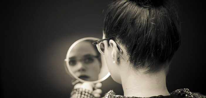 woman looking in the mirror