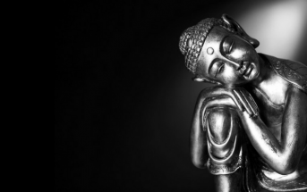 statue of Buddha against dark background