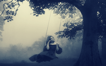 woman sitting on swing in fog