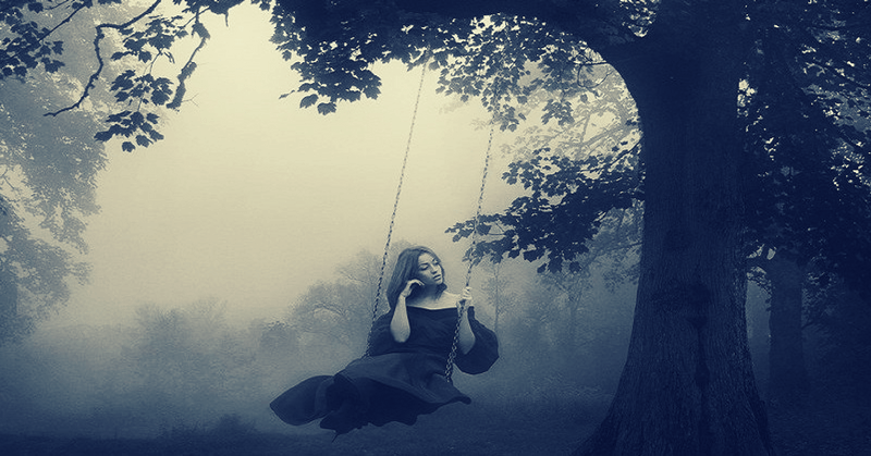 woman sitting on swing in fog