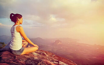 woman meditating on mountain - concept of inner peace