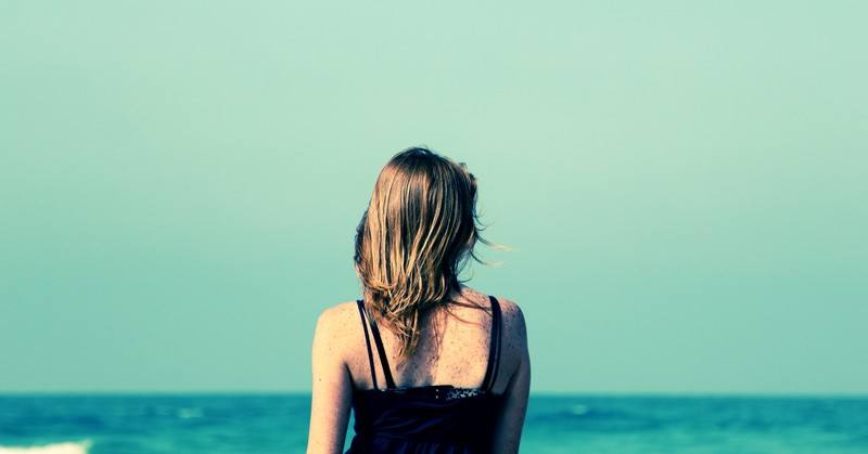 woman looking out across ocean