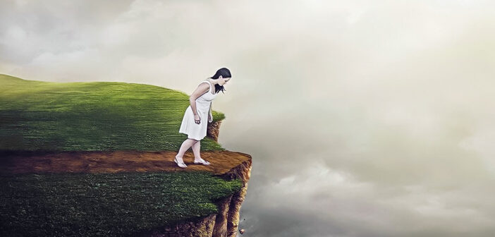 woman on brink of cliff - concept of existential crisis