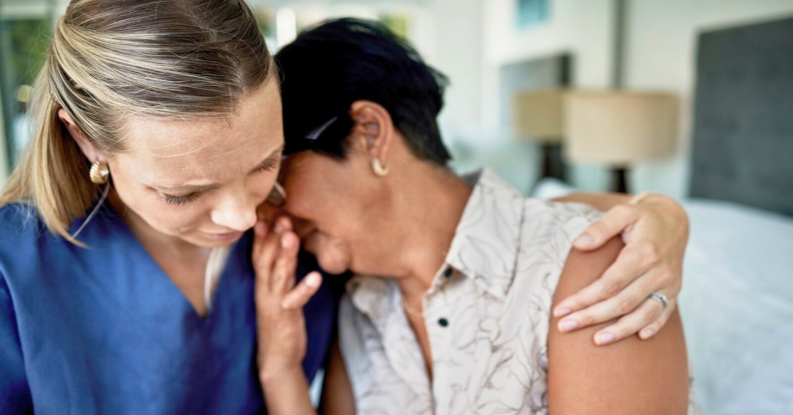 young woman consoling older woman who is in grief