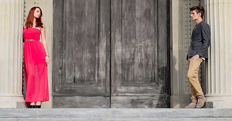 couple standing either side of door - concept of lack of empathy in a relationship