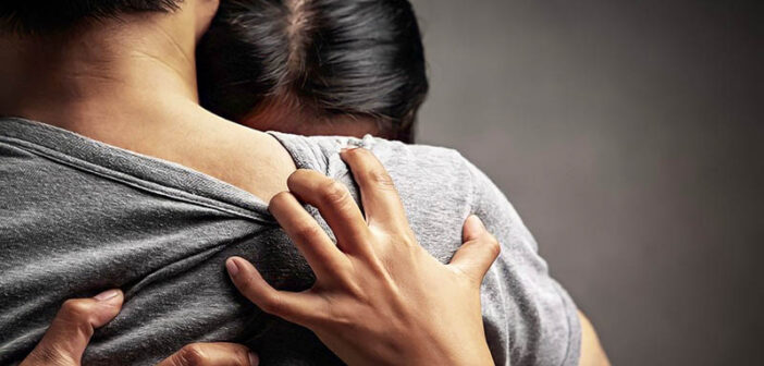 woman crying on man's shoulder - sorry for your loss