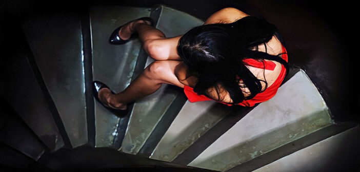 woman sitting on stairs crying - concept of abandonment issues