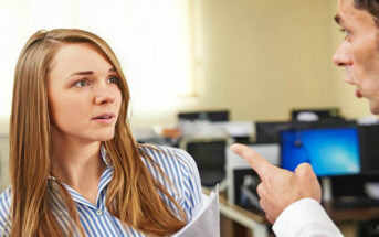 male boss pointing finger at female coworker - concept of control freak