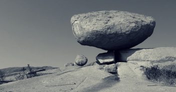 picture of a gray rock balancing in landscape