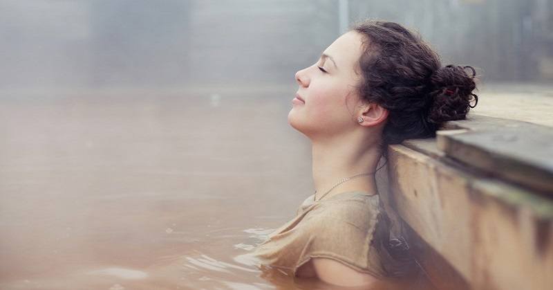 woman relaxing in natural spring - concept of highly sensitive person