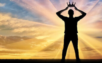 man holding crown above his head - concept of narcissist