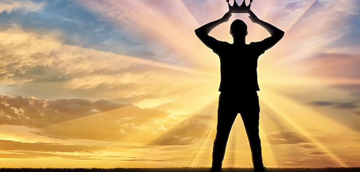 man holding crown above his head - concept of narcissist