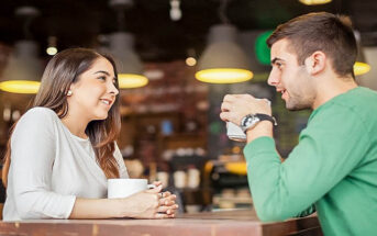 man and woman talking in coffee shop