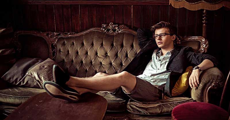 rich young man sitting in opulence - concept of entitlement