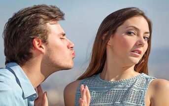 woman avoiding kiss from man - concept of unrequited love