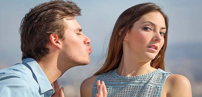 woman avoiding kiss from man - concept of unrequited love