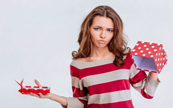 woman looking sad at empty gift box