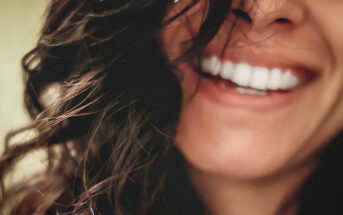 closeup of smiling woman to denote a positive person