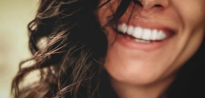 closeup of smiling woman to denote a positive person