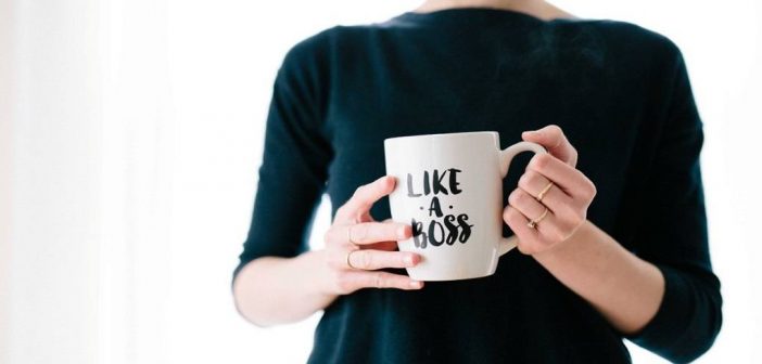 woman holding mug depicting a successful person