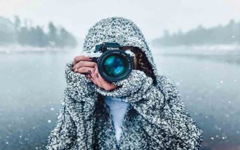 woman in snowy landscape pointing camera toward viewer - concept of free spirit jobs