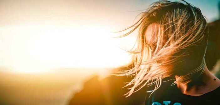 young woman on clifftop having quarter-life crisis
