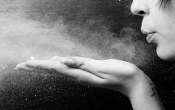 woman blowing powder from hand - letting go of control