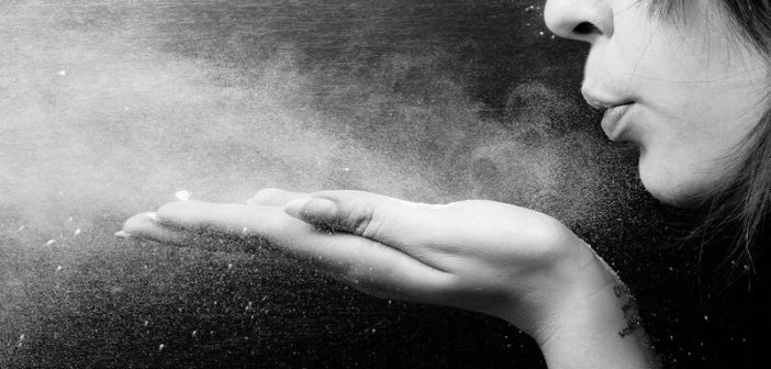 woman blowing powder from hand - letting go of control