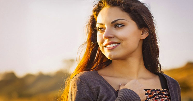 a young woman looking inspired watching the sunrise