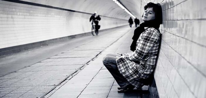 woman in subway walkway feeling like she doesn't belong