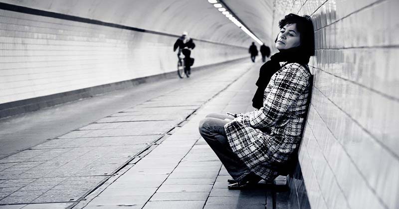 woman in subway walkway feeling like she doesn't belong