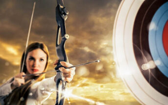woman with bow and arrow aiming at target to signify setting goals